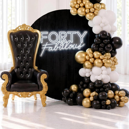 Decor noir et or avec toile de fond ronde en velours, trone royal et guirlande de ballons